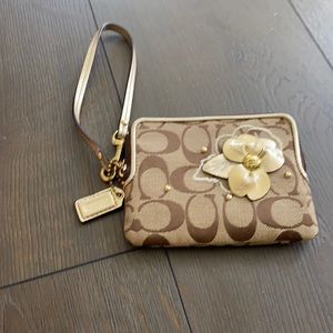Coach wristlet, decorative flower